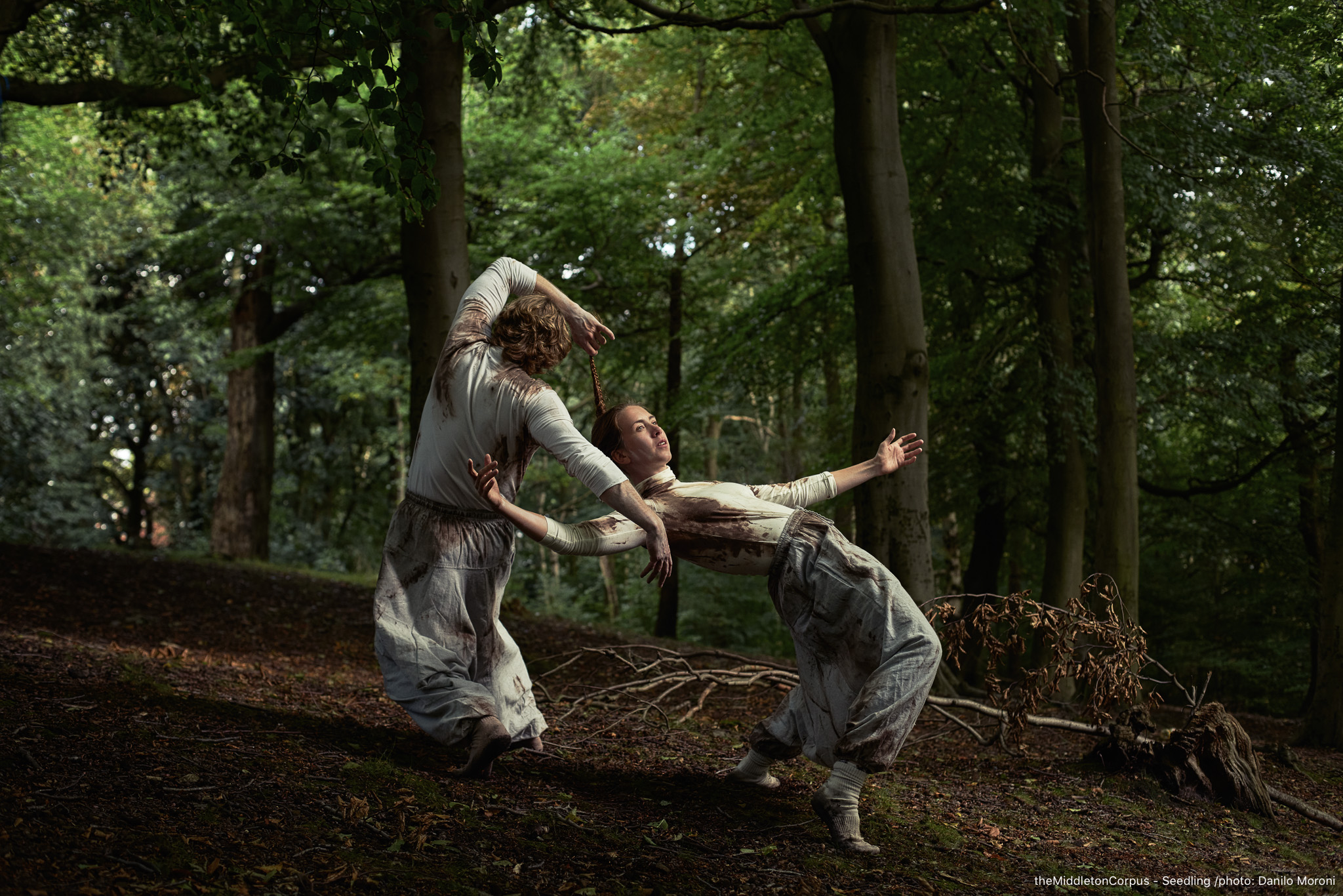 two performers dancing in the woods