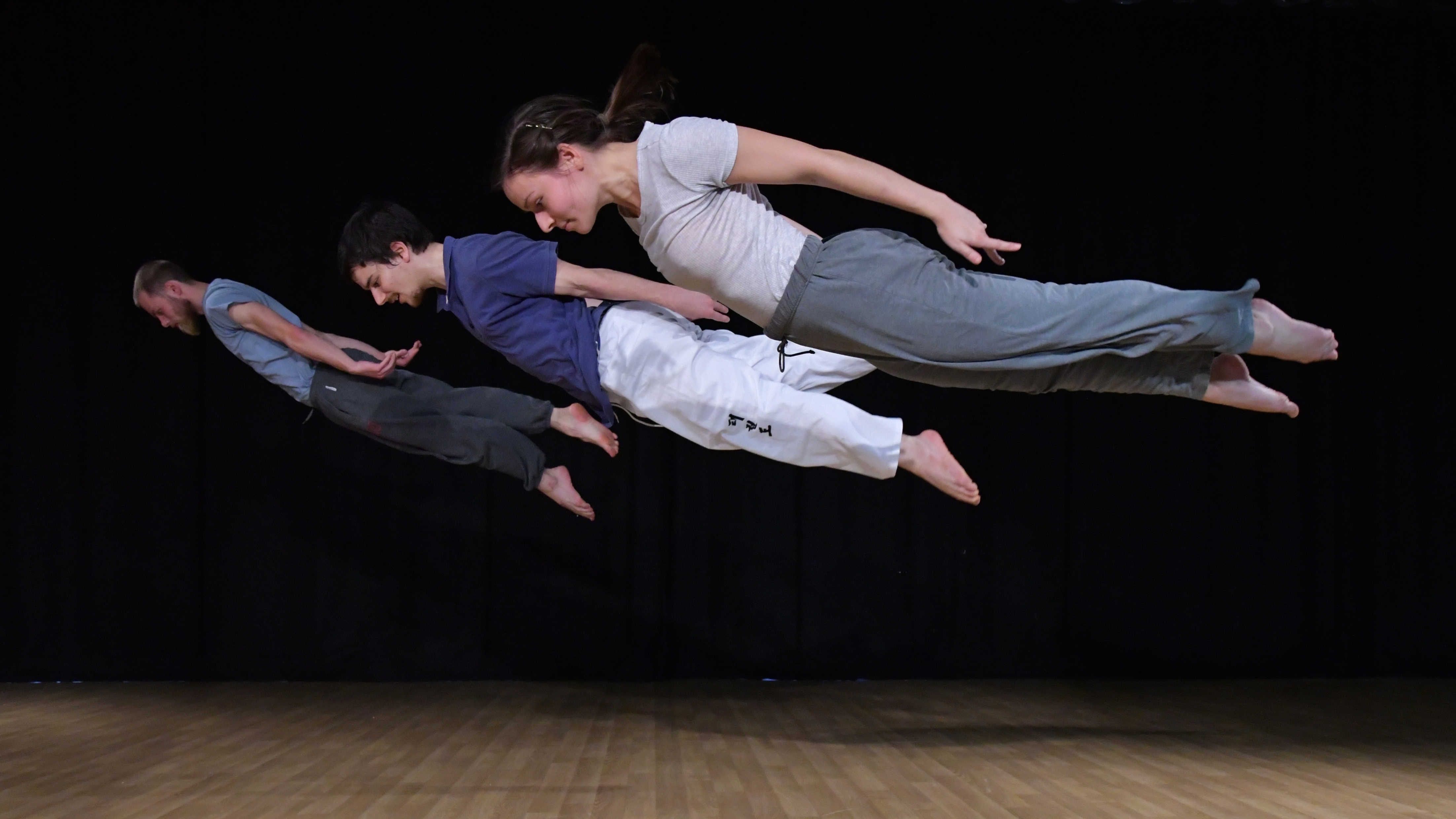 image of three people floating in performance