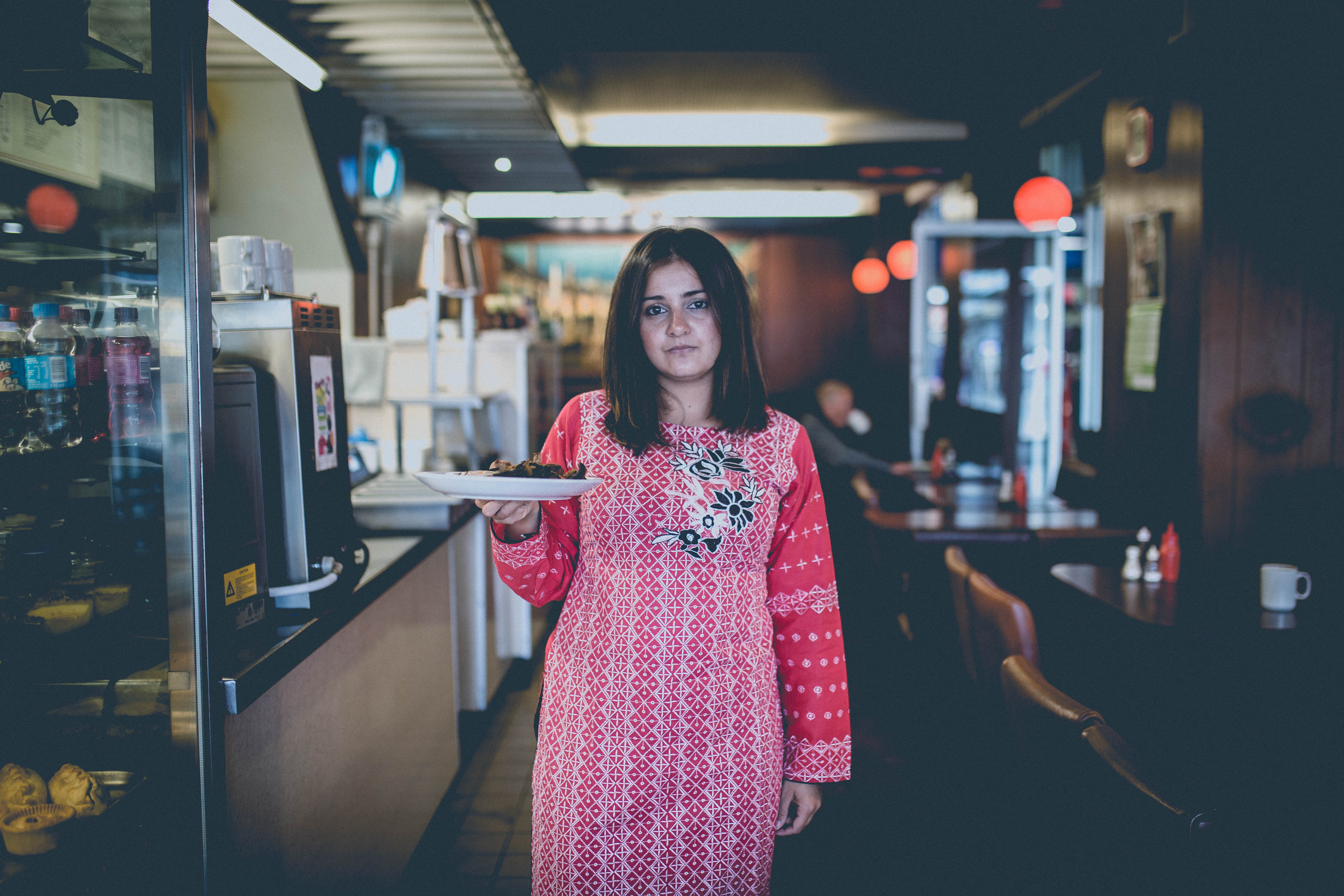 Woman holding a plate of food. Full English