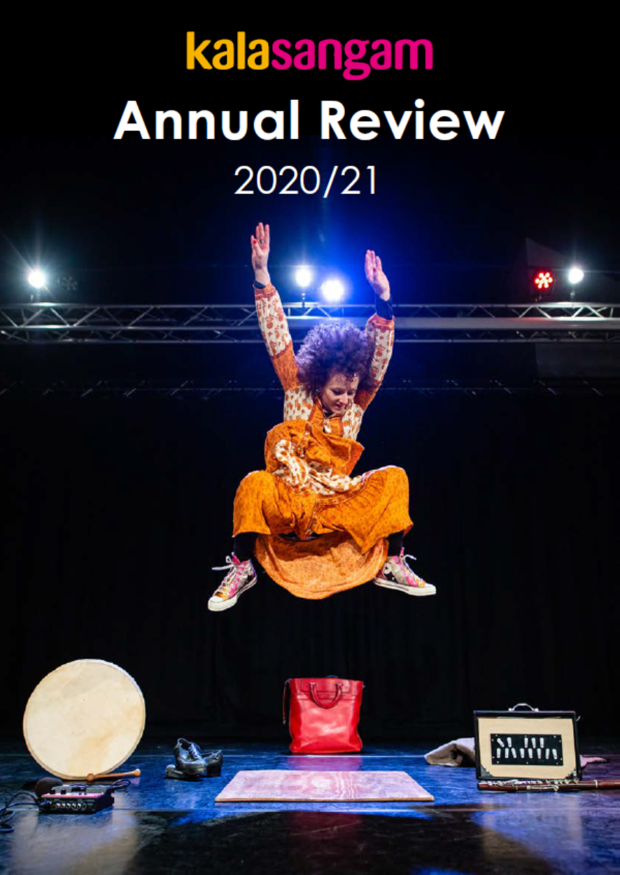 A women in an orange dress jumps against a black background. Title: Kalasangam Annual Review 2020/21