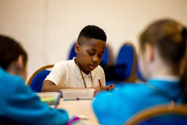 A young person drawing.