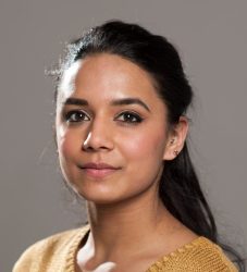 A head shot of a south Asian woman looking at the camera