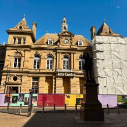 A photo of a sandstone building with a sign that reads 'bradford arts centre'