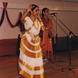 A woman in a white dress dancing